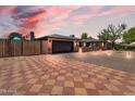Beautiful single-story home featuring a brick driveway, two-car garage, and drought-tolerant landscaping at 10602 N 35Th St, Phoenix, AZ 85028
