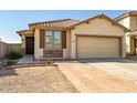 Charming single-story home featuring a well-manicured front yard and attached two-car garage at 11729 W Maui Ln, El Mirage, AZ 85335