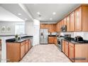 Modern kitchen featuring stainless steel appliances, granite countertops, and ample cabinet space at 11729 W Maui Ln, El Mirage, AZ 85335
