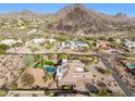 Breathtaking aerial view showing a backyard pool, lush landscaping, and stunning mountain views at 13126 E Turquoise Ave, Scottsdale, AZ 85259