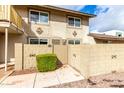 View of home with stucco exterior, decorative stone accents, and block wall surrounding front yard at 1316 N 85Th Pl, Scottsdale, AZ 85257