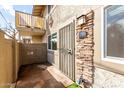 View of the front entrance featuring rock accents and a secure metal gate at 1316 N 85Th Pl, Scottsdale, AZ 85257