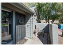 Cozy front porch featuring a secure metal door, 'hello' door mat and seating area at 14002 N 49Th Ave # 1094, Glendale, AZ 85306