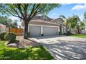 Attractive home with a spacious three-car garage and mature trees adding shade and charm at 1427 E Palomino Dr, Gilbert, AZ 85296