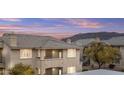 Beautiful multi-story condo with a tiled roof and desert landscaping, offering a serene living environment at 16013 S Desert Foothills Pkwy # 2120, Phoenix, AZ 85048
