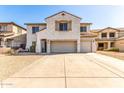 Charming two-story home with a three car garage, desert landscaping, and a neutral color palette at 19061 N Toya St, Maricopa, AZ 85138