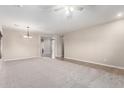 Bright and airy living room with neutral walls, carpeted floors, a ceiling fan and a chandelier at 19061 N Toya St, Maricopa, AZ 85138