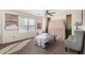 Bedroom with a ceiling fan and comfortable seating area at 24207 W Desert Bloom St, Buckeye, AZ 85326