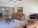 Bright living room featuring vaulted ceilings, a painting, and comfortable seating on a decorative rug at 2710 S Noche De Paz --, Mesa, AZ 85202