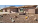 Inviting facade featuring desert landscaping, covered porch, and a three-car garage, enhancing curb appeal at 2842 S Royal Wood --, Mesa, AZ 85212