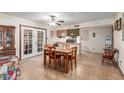 Cozy dining area featuring a classic table set, adjacent to the kitchen with ample light at 306 N Winthrop Cir, Mesa, AZ 85213