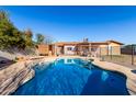 Sparkling blue pool surrounded by a patio, perfect for relaxing and entertaining outdoors at 306 N Winthrop Cir, Mesa, AZ 85213