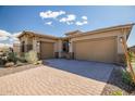 Spacious three-car garage with paved driveway and desert landscaping at 32297 N 133Rd Ln, Peoria, AZ 85383