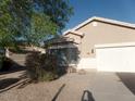 Inviting single-level home featuring a two-car garage, gravel landscaping, and a walkway to the front door at 39837 N Manetti St, San Tan Valley, AZ 85140