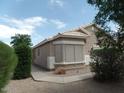 A side view of this desert home with a well-maintained yard and rock accents at 39837 N Manetti St, San Tan Valley, AZ 85140
