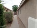Side view showcasing the home's exterior, walkway, and desert landscaping at 39837 N Manetti St, San Tan Valley, AZ 85140