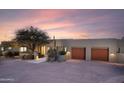 Beautiful exterior of a modern home with desert landscaping and a two-car garage at 40198 N 105Th Pl, Scottsdale, AZ 85262