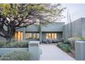 Charming modern home with desert landscaping, lush green shrubs and a unique front yard at 40198 N 105Th Pl, Scottsdale, AZ 85262