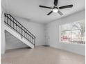 Open living area with staircase, tiled flooring, and a window for natural light at 4625 W Thomas Rd # 19, Phoenix, AZ 85031