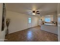 Open dining area with tile floors, seamlessly connecting to a well-lit kitchen area with white appliances at 4655 W Sunnyside Ave, Glendale, AZ 85304
