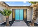 Eye-catching turquoise double front door framed by black trim and desert landscaping at 4743 W Laurel Ln, Glendale, AZ 85304