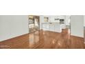 Open-concept living area with gleaming hardwood floors and access to the backyard at 4743 W Laurel Ln, Glendale, AZ 85304