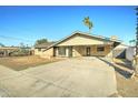 Charming single-story brick home with a long, paved driveway, and minimalist desert landscaping at 623 N Parsell --, Mesa, AZ 85203