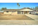 Charming single-story brick home featuring a covered carport and a drought-tolerant front yard at 623 N Parsell --, Mesa, AZ 85203
