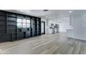 Open-concept living area with custom built-ins seamlessly flowing into a modern kitchen at 623 N Parsell --, Mesa, AZ 85203