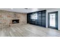 Bright living room featuring a brick fireplace, custom shelving, and modern flooring at 623 N Parsell --, Mesa, AZ 85203