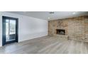Spacious living room with a brick fireplace, modern flooring, and a sliding glass door at 623 N Parsell --, Mesa, AZ 85203