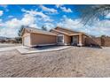 Single-story home with desert landscaping, a two-car garage, and a walkway to the front door at 6922 S 26Th Ln, Phoenix, AZ 85041