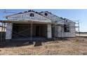 Image of new home construction showing framing with thermal wrap under a clear blue sky at 7691 W Saddlehorn Rd, Peoria, AZ 85383