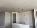 Interior view showing drywall in an open floor plan of a new home construction at 7691 W Saddlehorn Rd, Peoria, AZ 85383