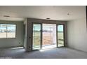 Picture of a living room with sliding glass doors leading to a view of the backyard at 7691 W Saddlehorn Rd, Peoria, AZ 85383