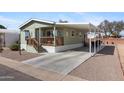 Charming home featuring a covered carport and welcoming front porch with a well maintained yard at 7807 E Main St # Cc-98, Mesa, AZ 85207