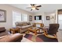 Bright living room featuring a comfortable seating arrangement, ceiling fan, and large windows at 7807 E Main St # Cc-98, Mesa, AZ 85207