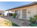 Single-story home entrance with a covered porch and desert landscaping at 8339 W Devonshire Ave, Phoenix, AZ 85037