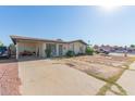 Single-story home featuring a covered carport and xeriscaped front yard at 8339 W Devonshire Ave, Phoenix, AZ 85037