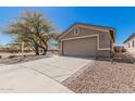 Charming single-story home featuring a two-car garage, mature landscaping, and a spacious driveway at 9644 N 97Th Ln, Peoria, AZ 85345