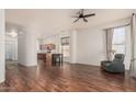 Open-concept living space featuring wood flooring, neutral walls, and a ceiling fan at 9644 N 97Th Ln, Peoria, AZ 85345