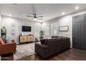 The living room showcases wood floors, a ceiling fan, and stylish furniture under natural light streaming through the windows at 10451 E Natal Ave, Mesa, AZ 85209