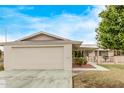 Ranch-style home showcasing a large garage and well-maintained front yard at 10516 W El Capitan Cir, Sun City, AZ 85351