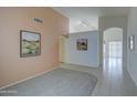 Bright entryway with neutral walls, tile flooring, and decorative wall art, creating a welcoming ambiance at 12450 W Holly St, Avondale, AZ 85392