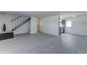 Bright living room with tile flooring, modern staircase, and ample natural light at 1320 E Bethany Home Rd # 104, Phoenix, AZ 85014