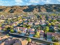 Expansive aerial view of a residential neighborhood nestled against a backdrop of scenic mountains at 1333 E Pedro Rd, Phoenix, AZ 85042