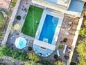 Aerial view of a backyard featuring a sparkling pool, manicured lawn, gazebo and outdoor seating area at 1333 E Pedro Rd, Phoenix, AZ 85042