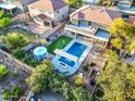 Aerial view of a backyard featuring a sparkling pool, manicured lawn, outdoor kitchen and gazebo at 1333 E Pedro Rd, Phoenix, AZ 85042