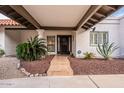 Welcoming entrance with tiled walkway, desert plants, and a secure front door at 15327 E Thistle Dr, Fountain Hills, AZ 85268