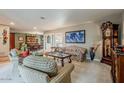 Comfortable living room featuring a cozy sitting area and dining room in the background at 15327 E Thistle Dr, Fountain Hills, AZ 85268